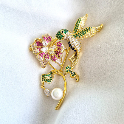 Goldene Brosche Kolibri, golden brooch, broche, spilla, Goldene Kolibri-Brosche mit Blume, bunten CZ-Steinen und weißer Perle – 18K vergoldetes Kupfer, romantisch-verspielter Schmuckstil